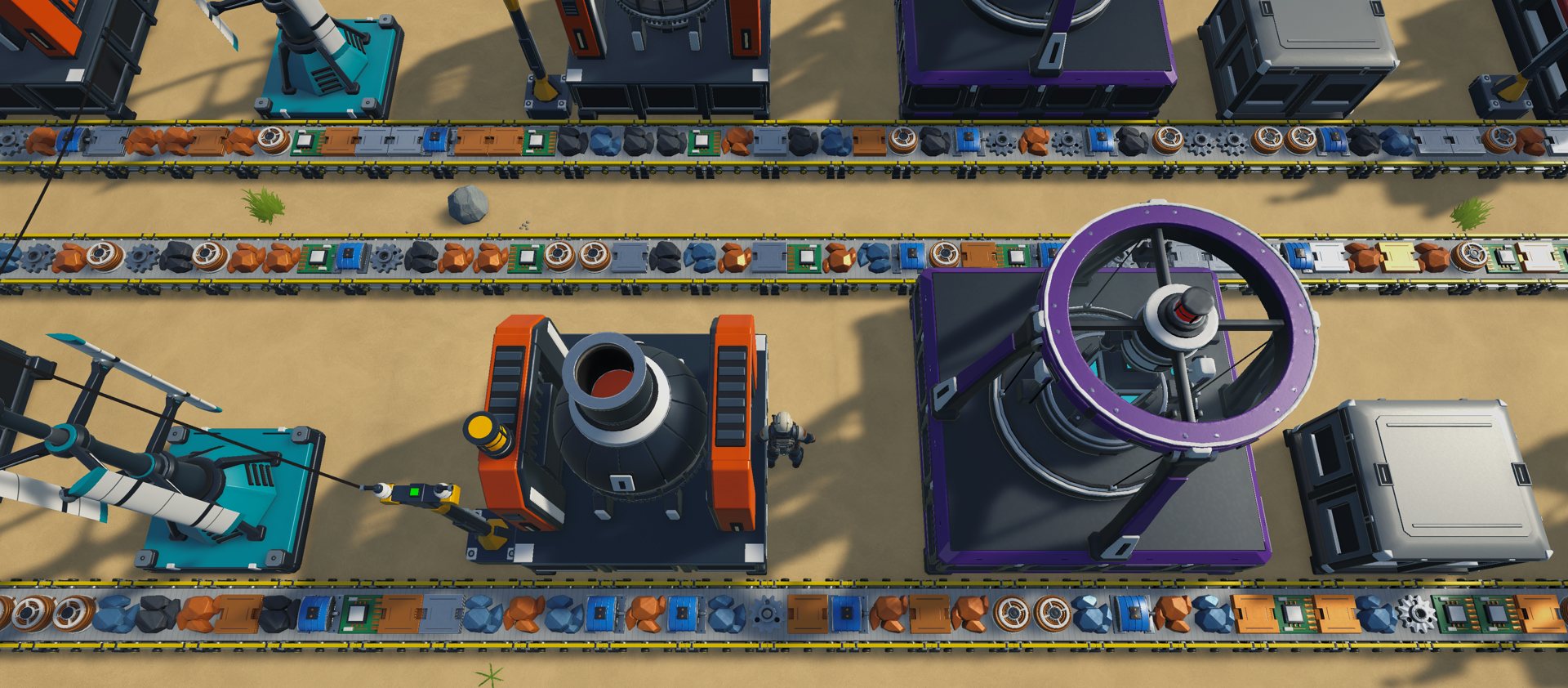 Top-down view of a dense factory: rows of smelters and assemblers fed by loaded belts